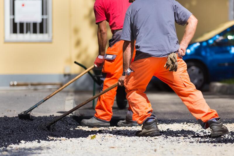 man doing asphalt repair